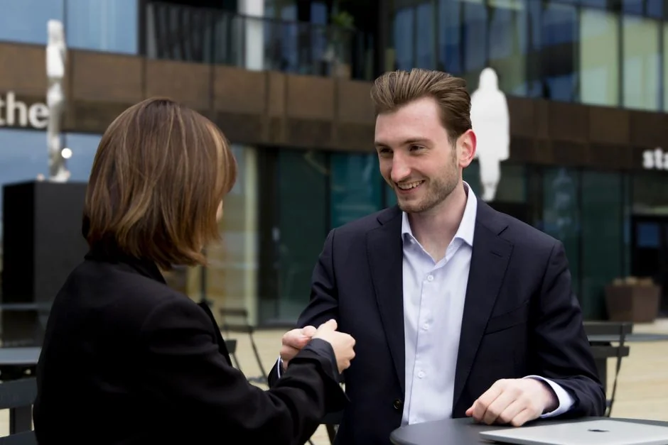 Focused business analysis with charts and graphs on a laptop in a modern office setting.